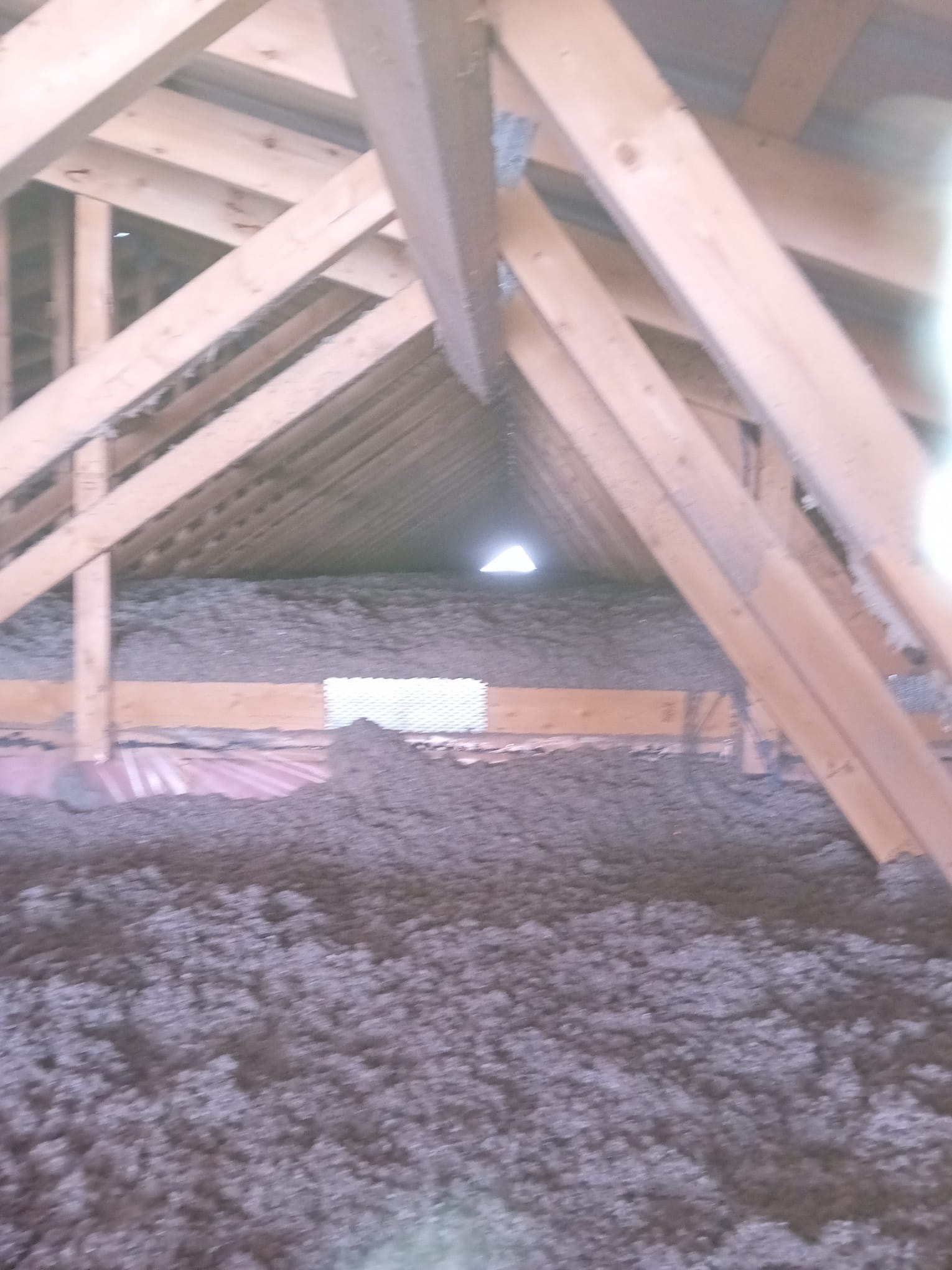 Blown-in insulation installation in residential attic